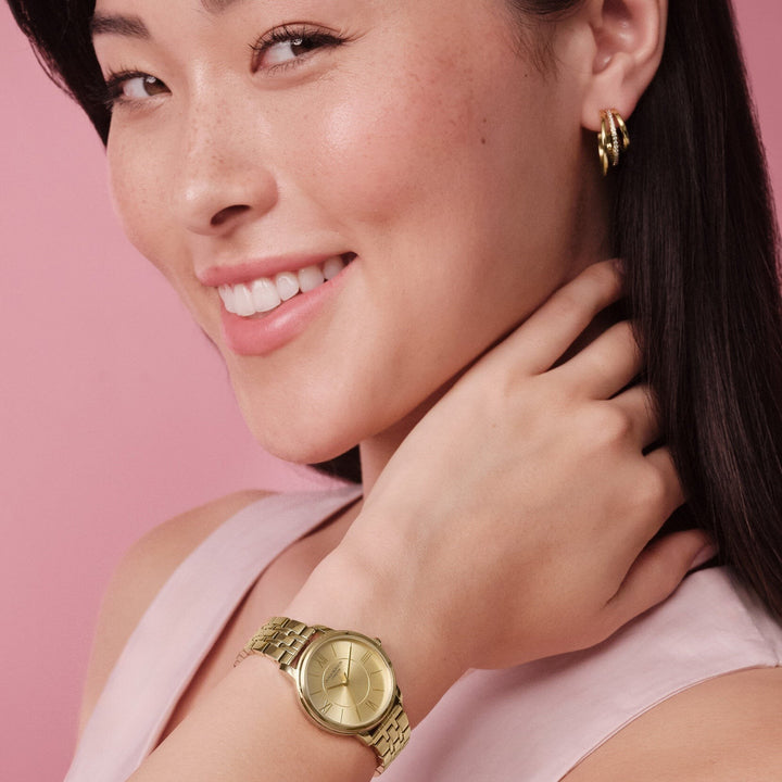 Niche Jewellery Olivia Burton Westbourne watch with a champagne dial and gold-tone bracelet on a woman's wrist