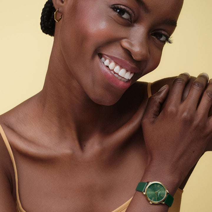 Niche Jewellery Olivia Burton Westbourne watch with a deep green leather strap and polished gold-tone case on a model