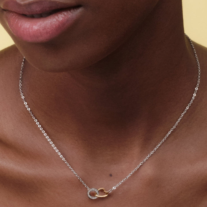 Niche Jewellery Olivia Burton Kindred necklace featuring interlinked silver and rose gold hearts on a delicate chain