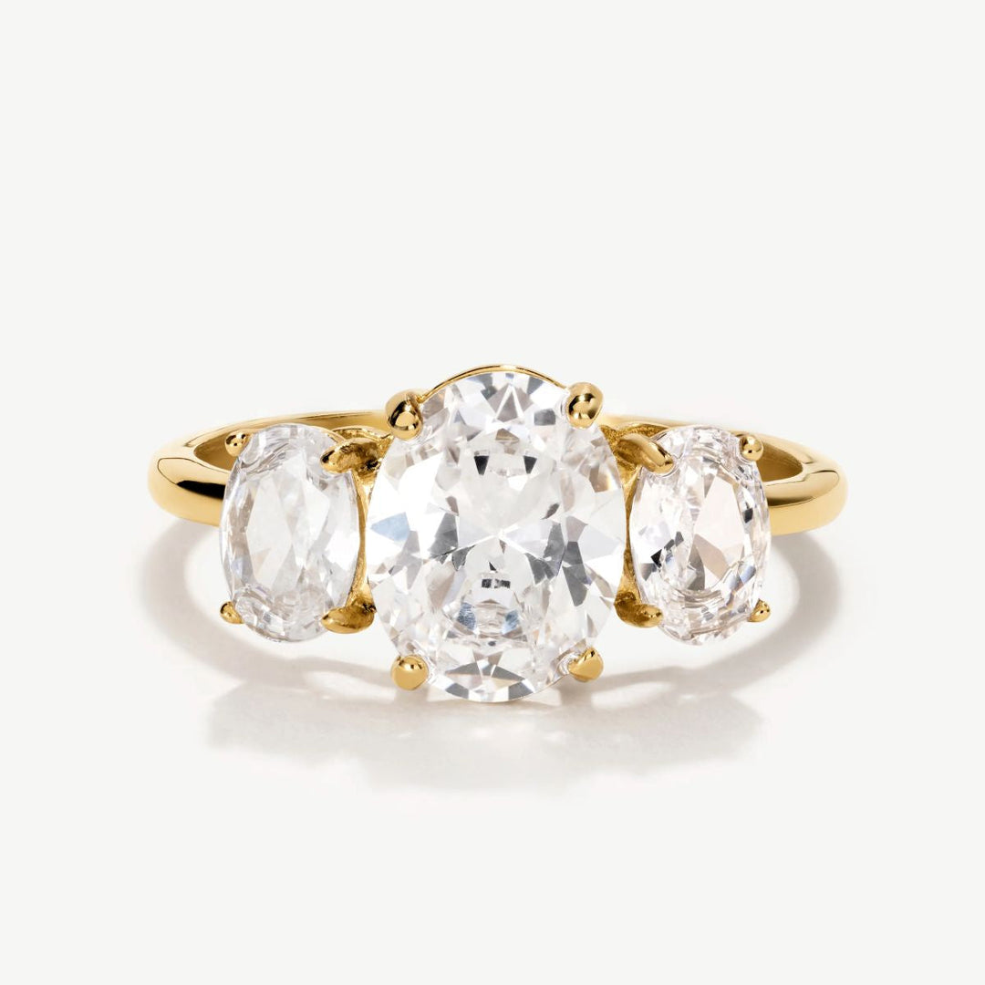 Niche Jewellery D.Louise gold trilogy ring featuring three oval-cut clear stones in a classic setting.