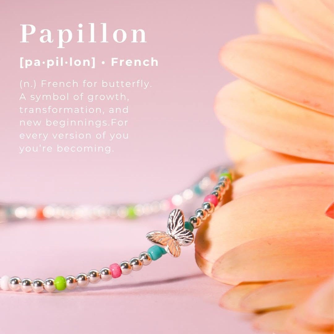 Niche Jewellery Annie Haak Papillon bracelet with sterling silver beads, neon accents, and a butterfly charm.