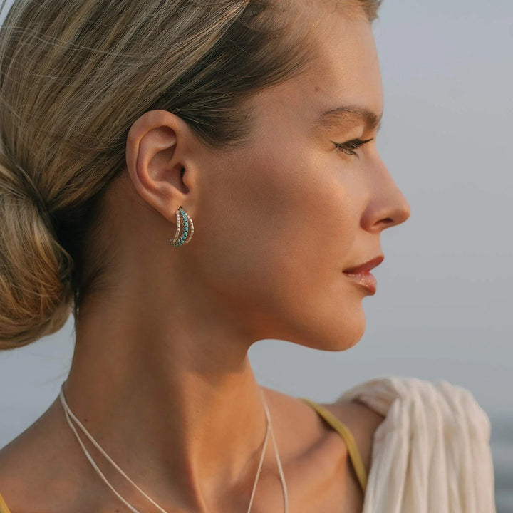 Niche Jewellery Charlotte's Web Parvati sterling silver hoop earrings with turquoise stones worn by a woman