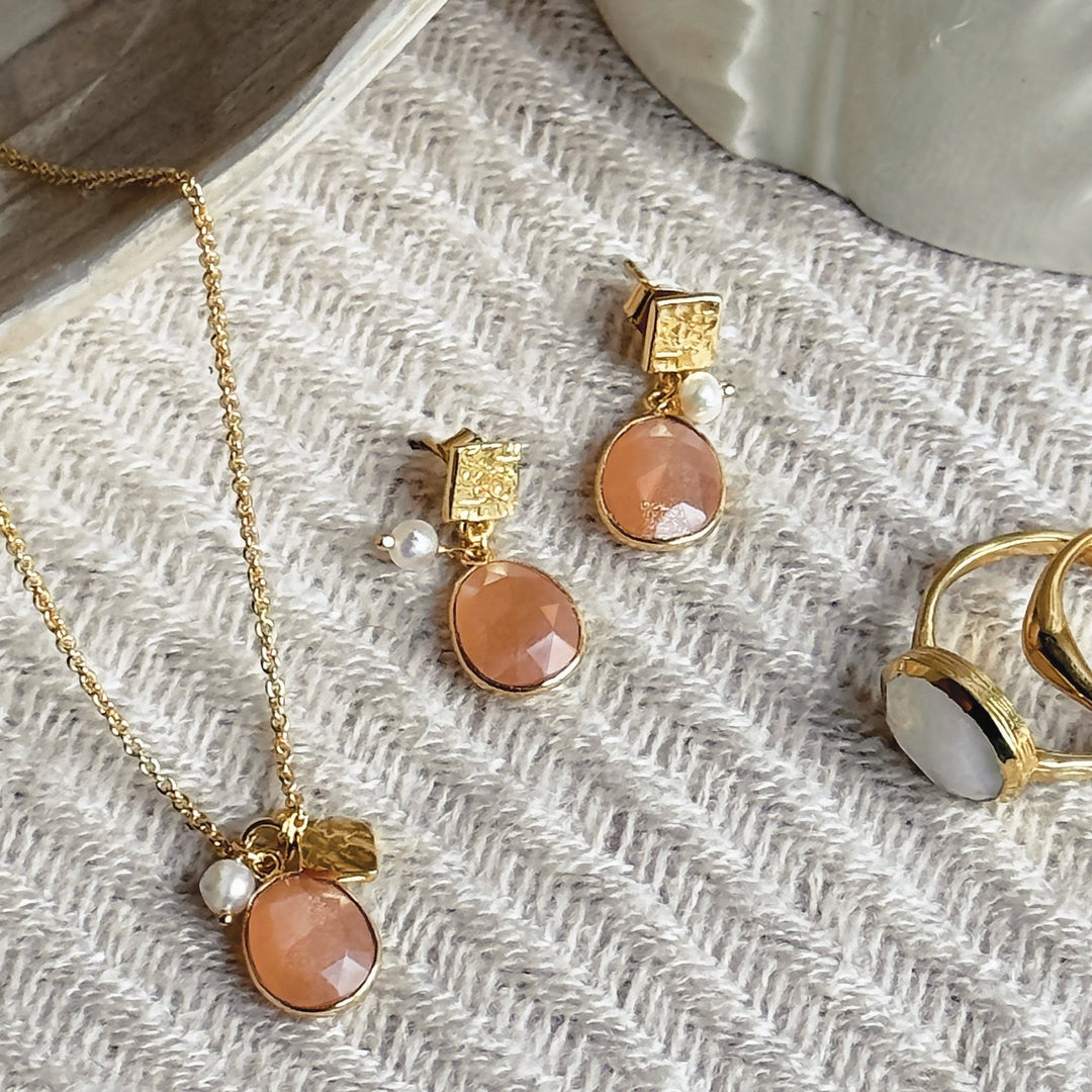 Niche Jewellery Sarah Alexander gold-plated earrings with peach moonstone, pearls, and textured organic charms.