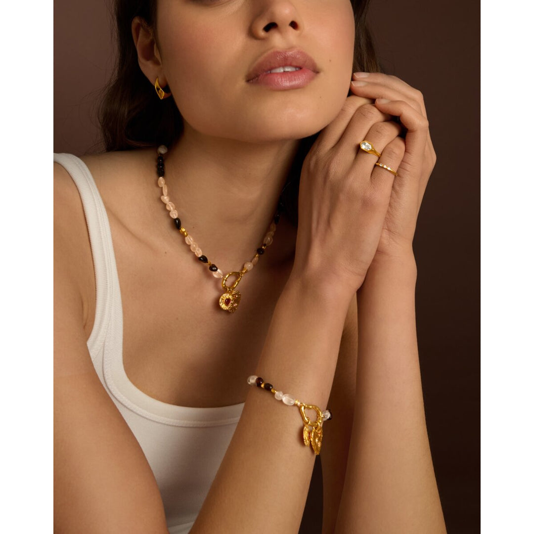 Niche Jewellery Katie Loxton Cherie pink stone and gold-tone waterproof bracelet worn on a model's wrist