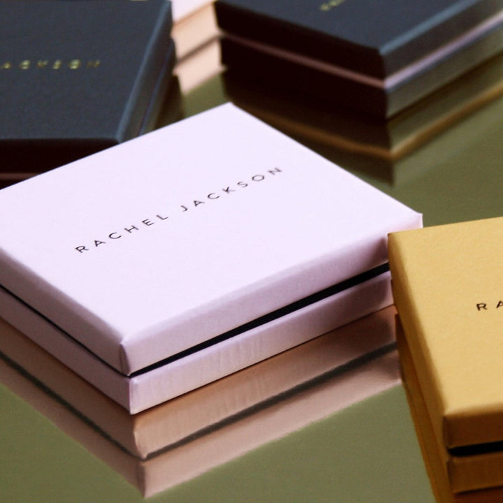 Niche Jewellery branded Rachel Jackson gift box in pale pink on a reflective surface