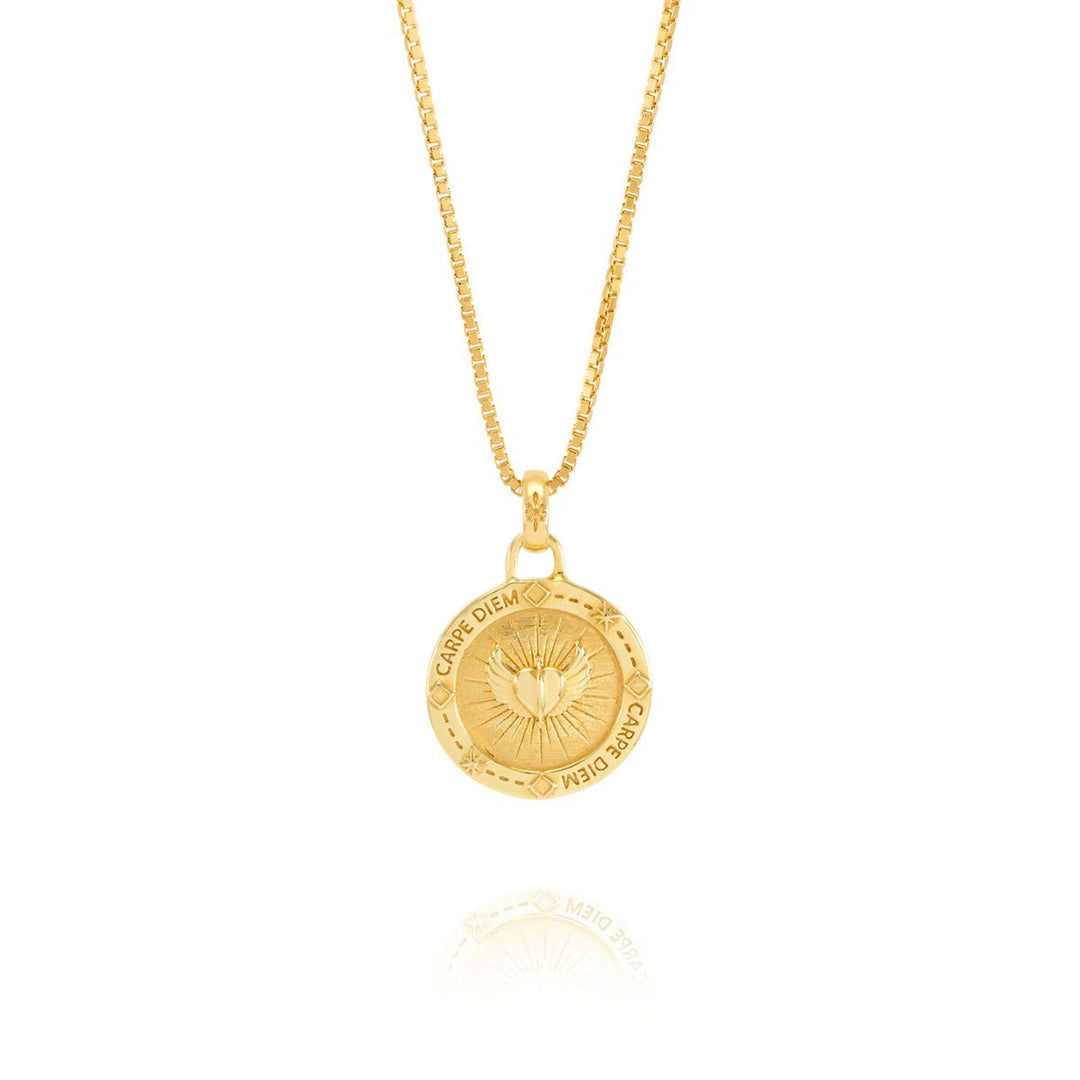 Niche Jewellery Rachel Jackson gold Carpe Diem necklace featuring a circular pendant with heart and wing engravings.