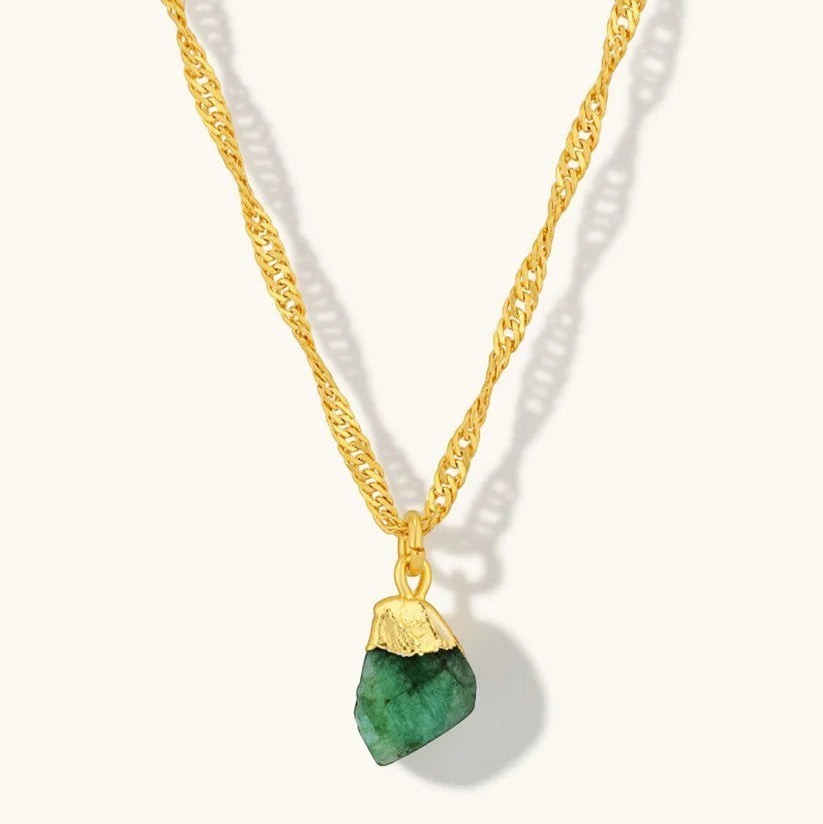 Niche Jewellery Mohica necklace featuring a raw-cut emerald pendant on an 18k gold plated sterling silver chain.