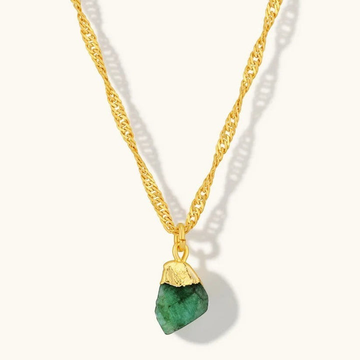 Niche Jewellery Mohica necklace featuring a raw-cut emerald pendant on an 18k gold plated sterling silver chain.