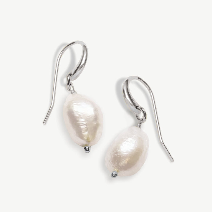 Niche Jewellery Ivory & Co Saint Lucia rhodium and ivory baroque pearl drop earrings with luxury fishhook fastening.