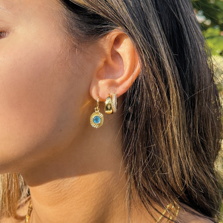 Niche Jewellery Sarah Alexander Samoa drop earrings with blue gemstone talisman on a model wearing an ear stack.