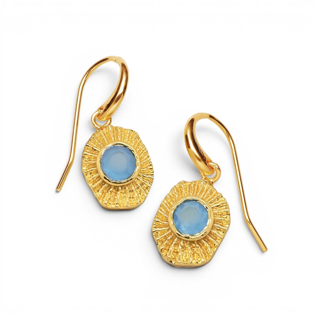 Niche Jewellery Sarah Alexander Samoa gold drop earrings with textured talisman charms and blue gemstone centers.