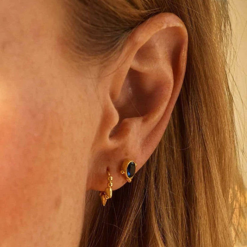 Niche Jewellery Formation Co Indus sapphire blue stud earring in 18k gold plated sterling silver worn on ear lobe