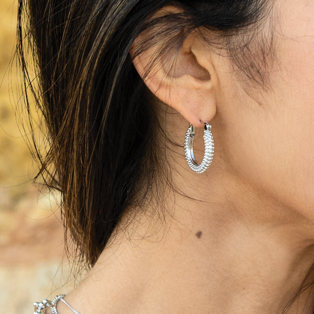 Niche Jewellery Sarah Alexander Sedona rhodium-plated silver bobble hoop earrings worn on a model