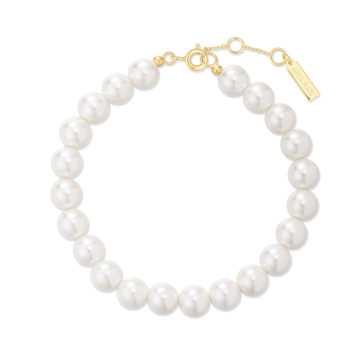 Niche Jewellery Ania Haie gold-toned bracelet featuring lustrous white shell pearls and a delicate clasp detail.