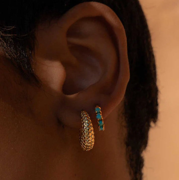 Niche Jewellery Formation Co Shore oval gold hoop earrings with textured finish worn on earlobe