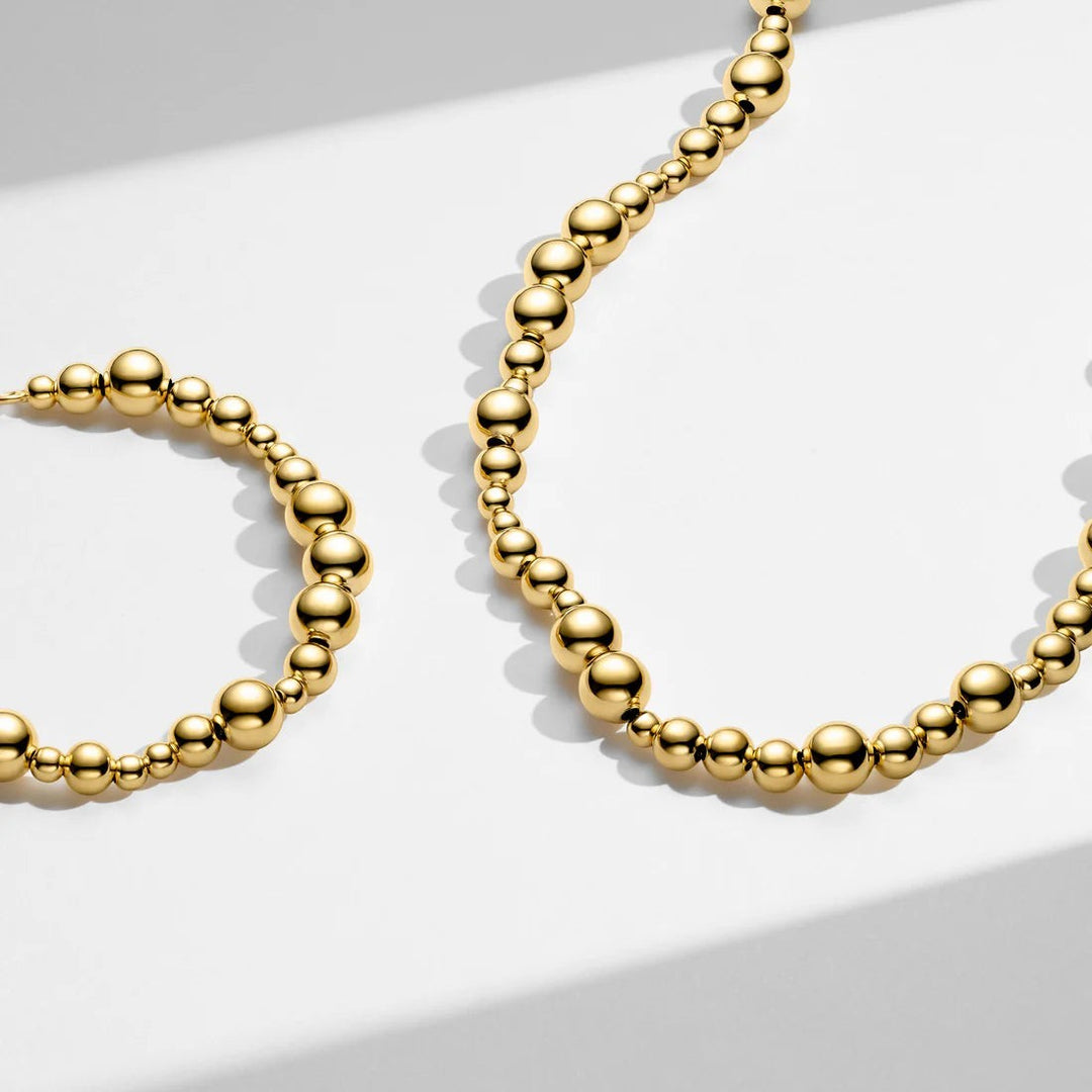 Niche Jewellery Sif Jakobs Bormio gold-plated sterling silver necklace with polished bubble beads on white surface.