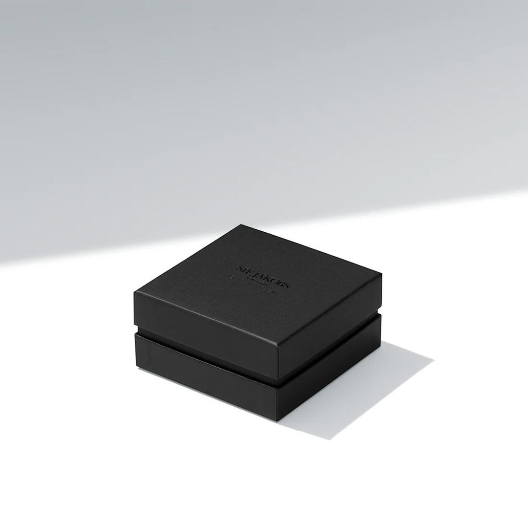 Niche Jewellery branded black gift box for the Sif Jakobs Bormio gold necklace on a clean white surface.