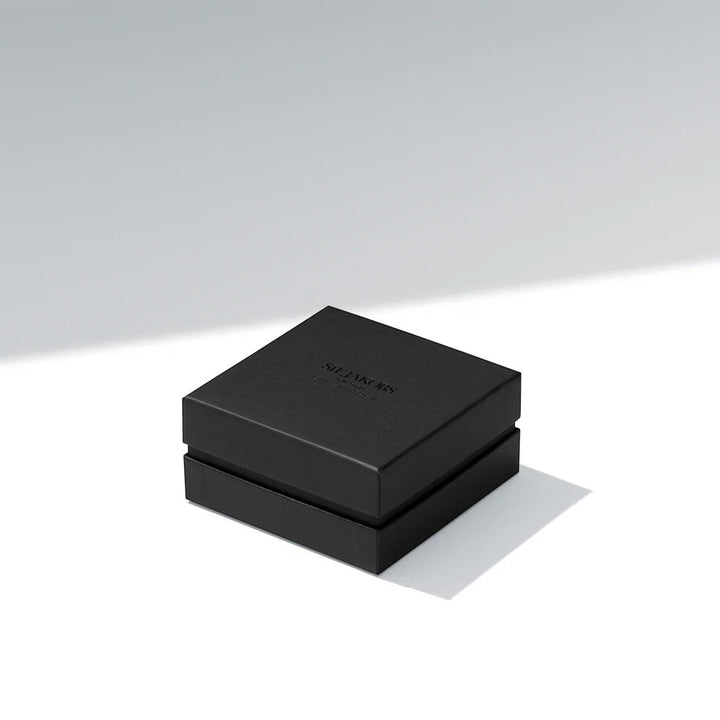 Niche Jewellery branded black gift box for the Sif Jakobs Bormio gold necklace on a clean white surface.
