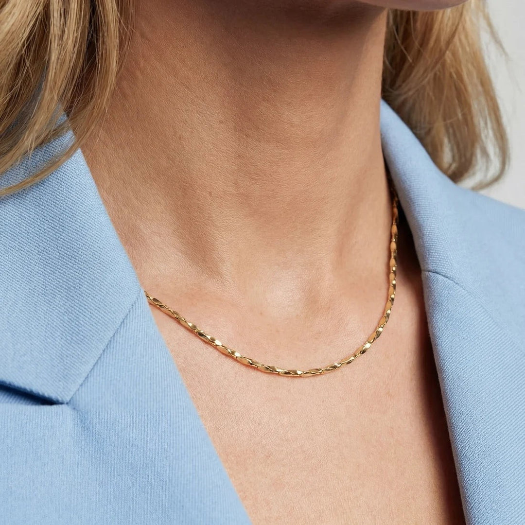 Niche Jewellery Sif Jakobs Savona gold-plated sterling silver chain necklace worn on a model in a light blue blazer.