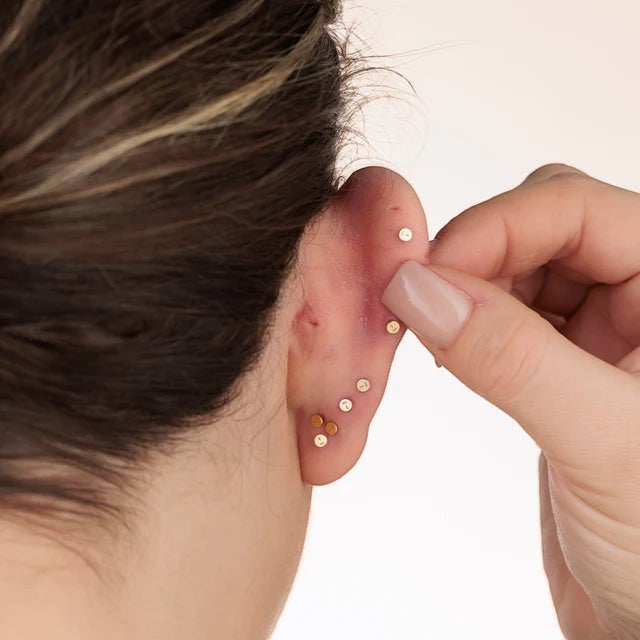 Niche Jewellery Scream Pretty sterling silver teeny flower flat back earring worn as a dainty ear stack