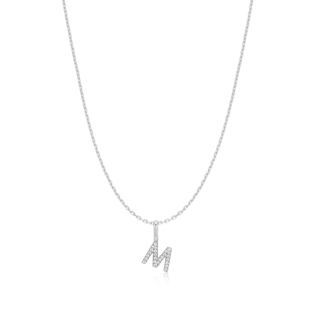 Niche Jewellery Ania Haie sterling silver necklace featuring a delicate letter M initial pendant with small crystals.