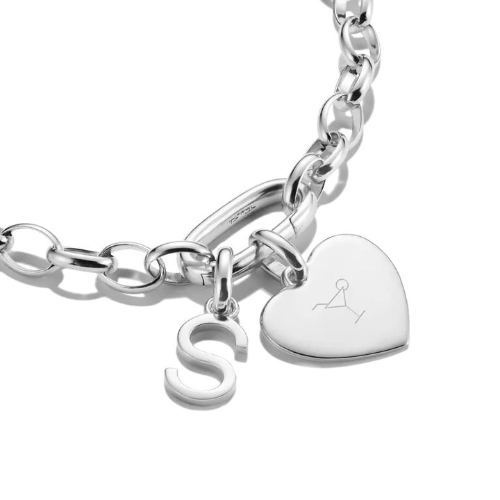 Niche Jewellery Sterling silver charm pendant shaped like the letter S, attached to a bracelet with a heart charm.