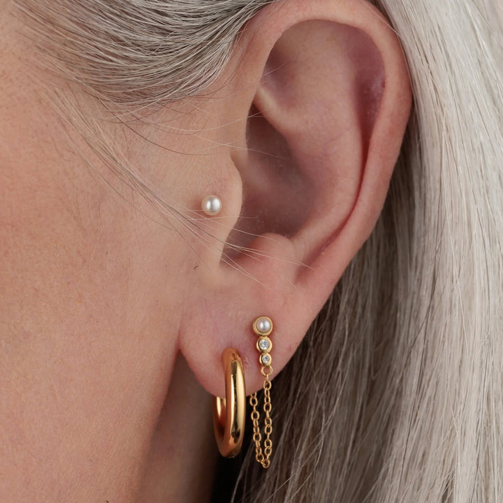 Niche Jewellery Scream Pretty silver pearl flat back stud earring worn in a tragus piercing for elegant layering
