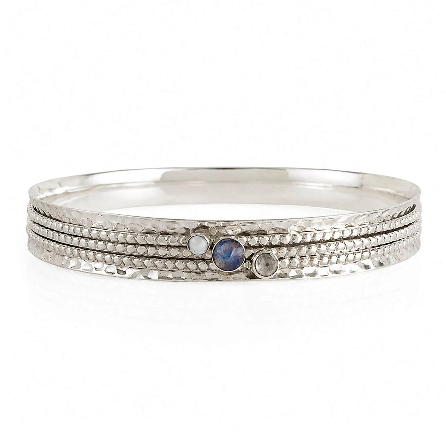 Niche Jewellery Charlotte's Web sterling silver spinning bangle featuring labradorite, white topaz, and iridescent pearl gemstones.