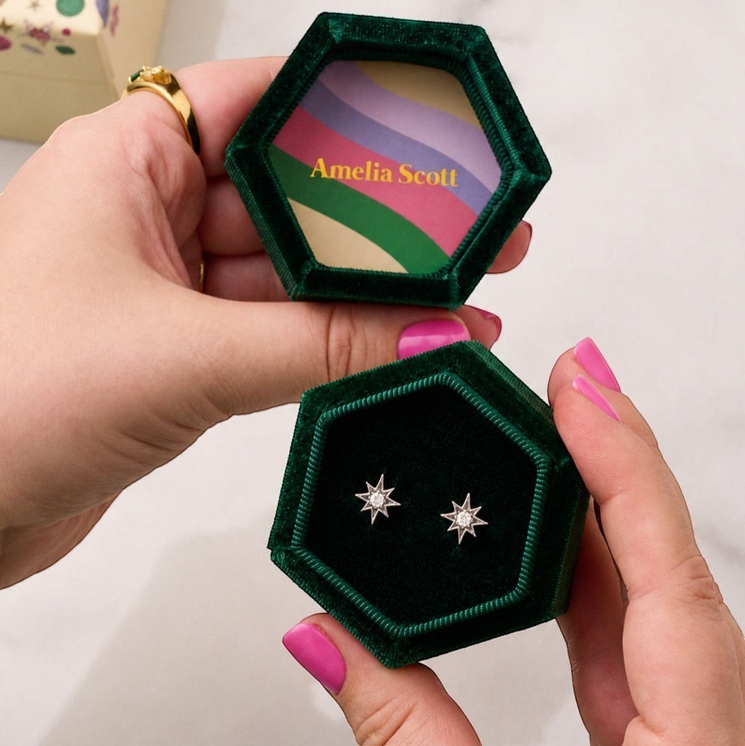Amelia Scott Ziggy Mini North Star Silver Stud Earrings with clear zirconia in a green velvet box.