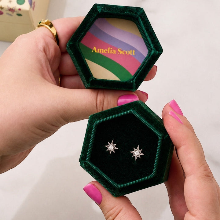 Amelia Scott Ziggy Mini North Star Silver Stud Earrings with clear zirconia in a green velvet box.
