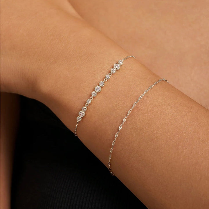 Niche Jewellery Ania Haie silver textured chain bracelet layered with a delicate diamond-style stone bracelet on wrist