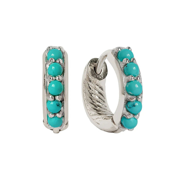 Niche Jewellery Charlotte's Web Kali huggie hoops in recycled silver featuring a row of vibrant turquoise stones.