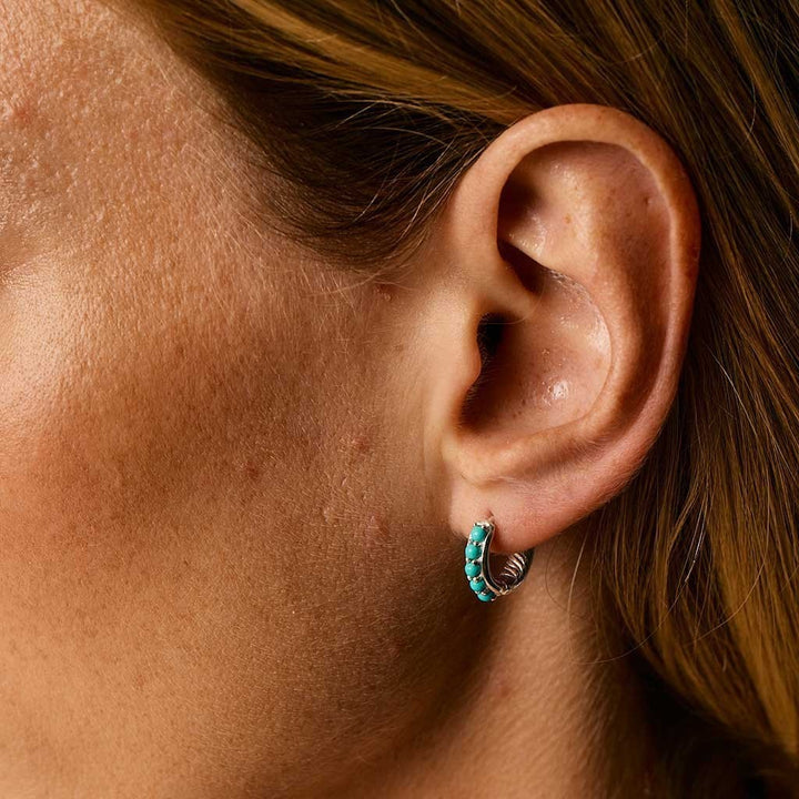 Niche Jewellery Charlotte's Web Kali huggie hoops in recycled sterling silver with inlaid turquoise stones on ear
