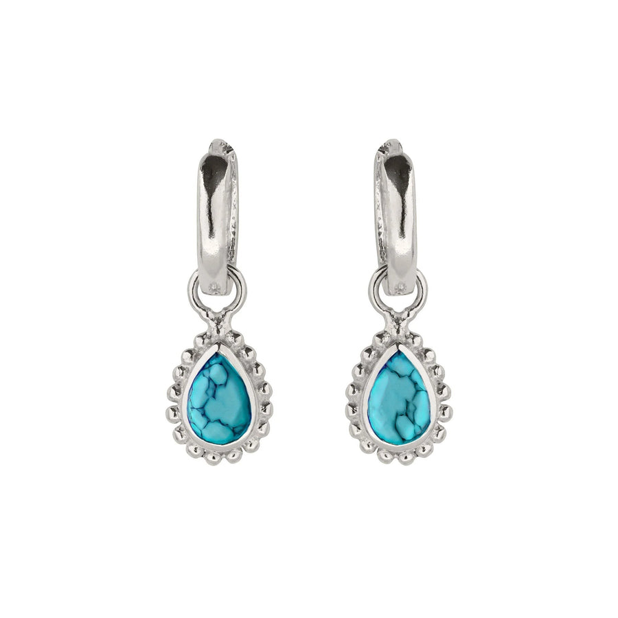 Niche Jewellery Charlotte's Web sterling silver huggie hoops featuring pear-cut turquoise December birthstones.