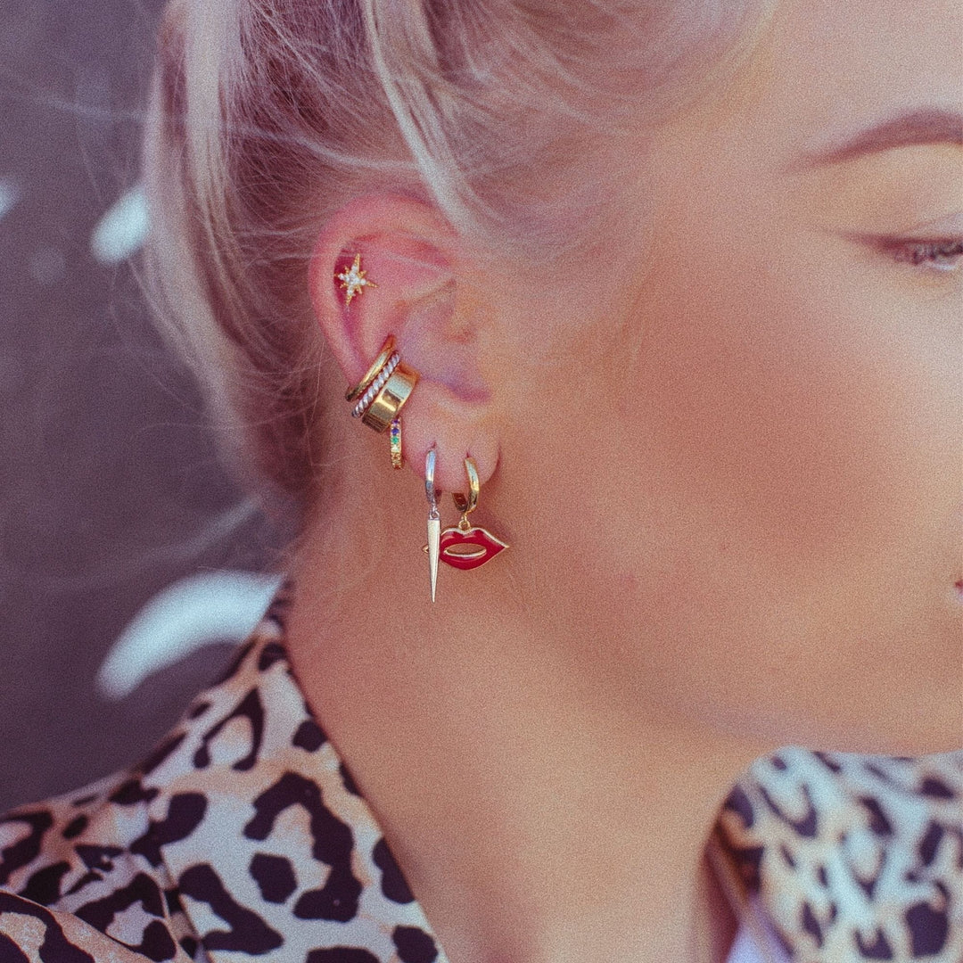 Niche Jewellery Scream Pretty slim gold ear cuff worn on a model with a curated ear stack of studs and hoops.