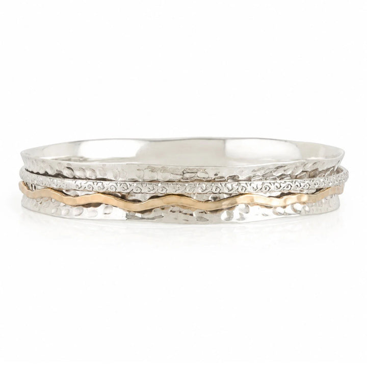 Niche Jewellery Charlotte's Web Aura Magic spinning bangle in recycled sterling silver and warm brass with wavy band