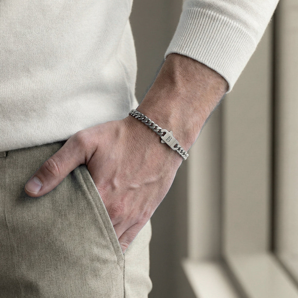 Niche Jewellery Steel & Barnett stainless steel link chain bracelet on a man's wrist with a branded clasp