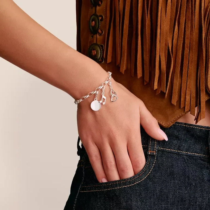 Niche Jewellery Thomas Sabo sterling silver interlocking hearts charm bracelet worn on a woman's wrist