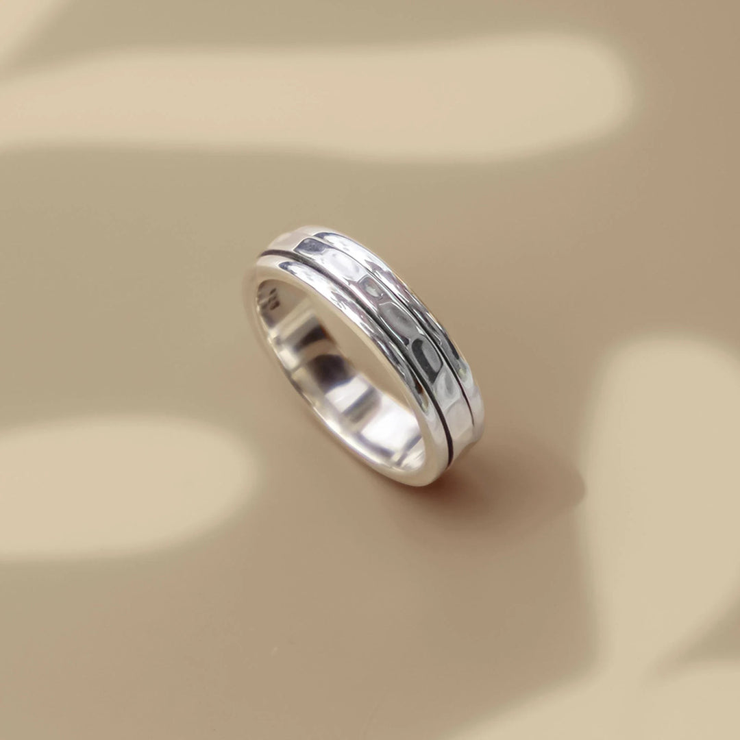 Niche Jewellery Charlotte's Web sterling silver spinning ring with a hammered texture, inspired by Tibetan prayer wheels.