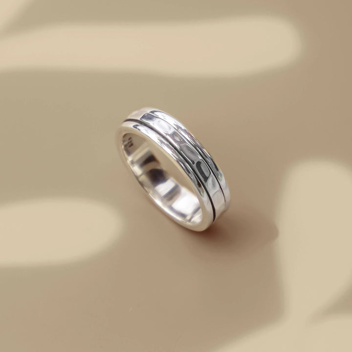 Niche Jewellery Charlotte's Web sterling silver spinning ring with a hammered texture, inspired by Tibetan prayer wheels.