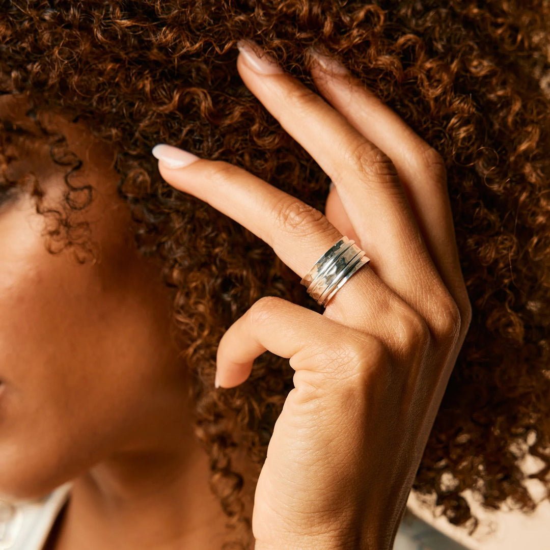 Niche Jewellery Charlotte's Web sterling silver Karma Abundance spinning ring worn on a woman's finger