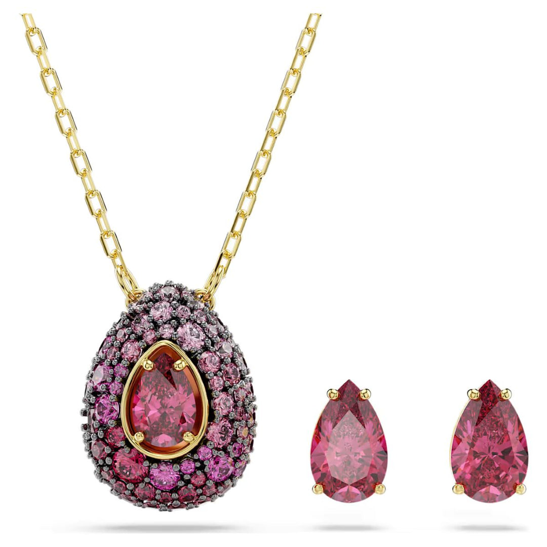 Niche Jewellery Swarovski Sublima set featuring a pear-cut red crystal pendant and matching earrings in gold finish.