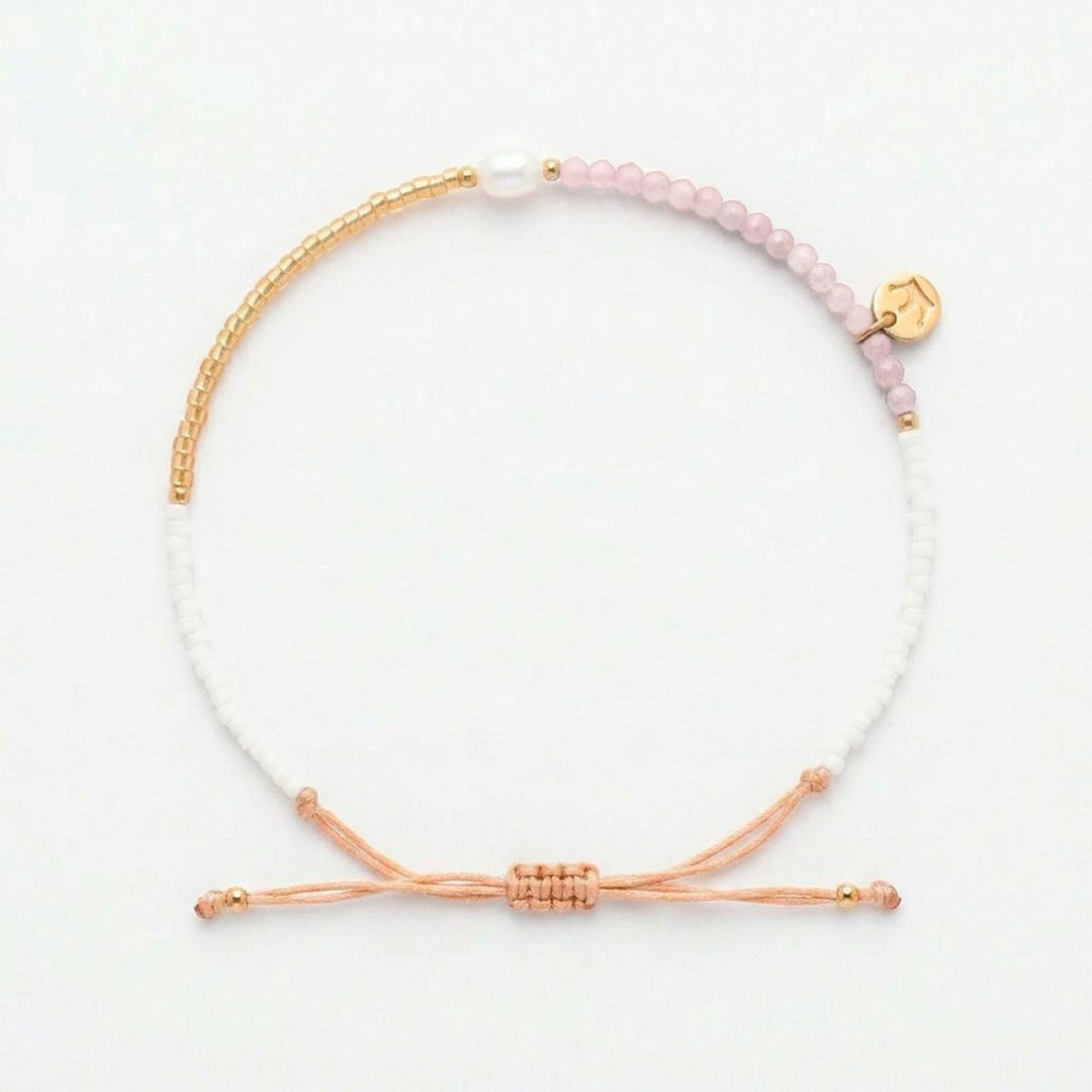 Niche Jewellery Jersey Pearl Noma bracelet featuring pink sunstone, white pearl, and gold-tone beads on a drawstring.