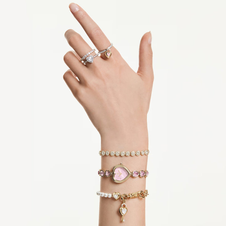 Niche Jewellery Swarovski Una Angelic bracelet with clear crystals and gold-tone plating worn on a woman's wrist