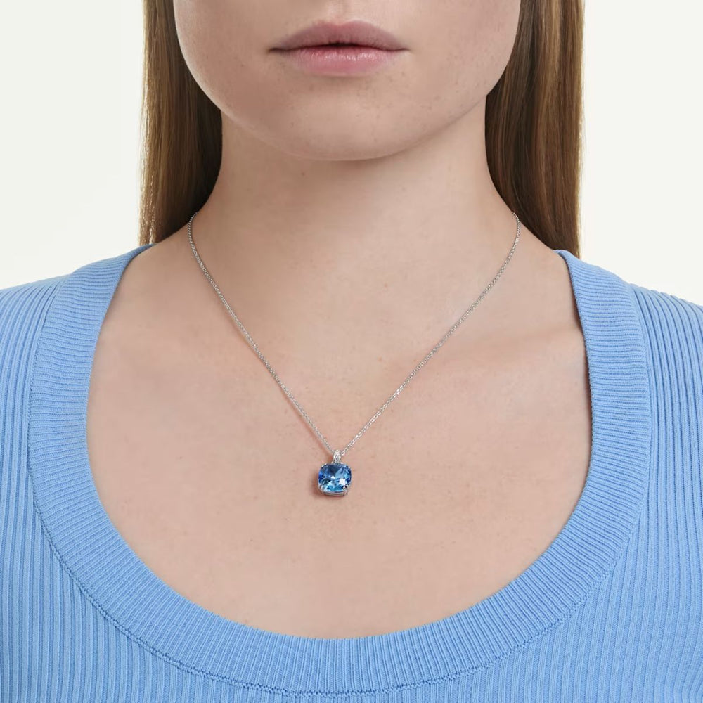 Niche Jewellery Swarovski Millenia pendant necklace featuring a blue cushion-cut crystal on a rhodium-plated chain.