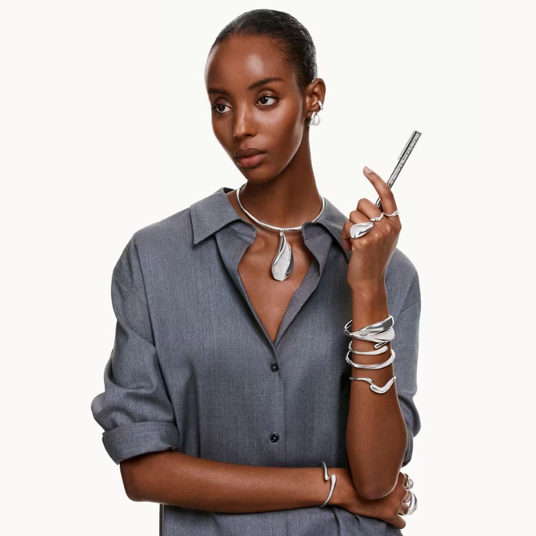 Niche Jewellery Swarovski Classica small round-cut white crystal hoop earrings worn by a model in a grey shirt