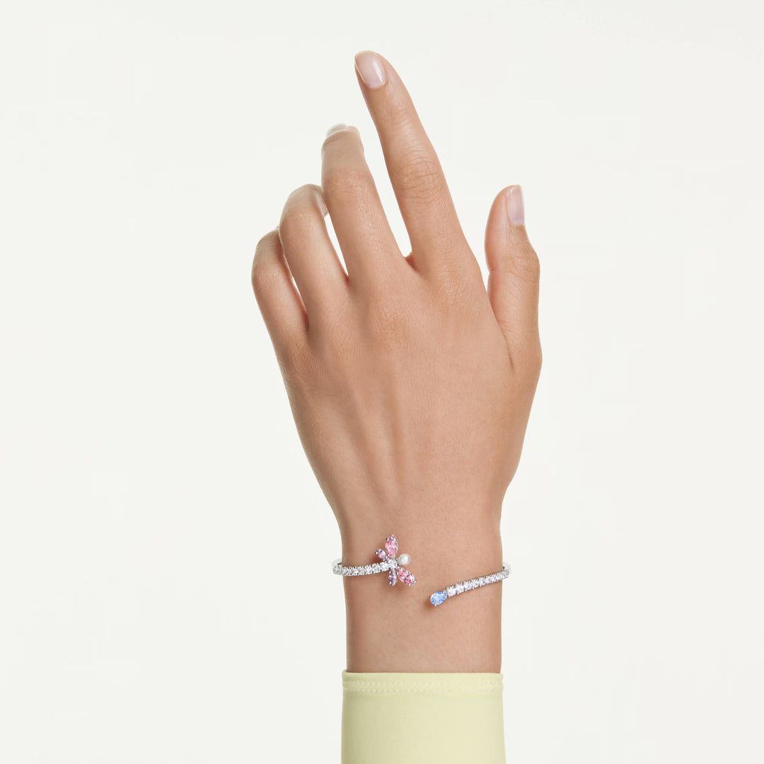 Niche Jewellery Swarovski x Ariana Grande rhodium-plated bangle featuring a multicolored crystal dragonfly motif.