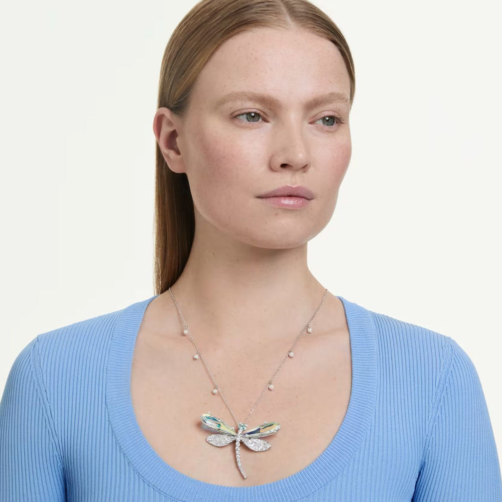 Niche Jewellery Swarovski x Ariana Grande dragonfly pendant necklace with clear crystals and rhodium plating on model