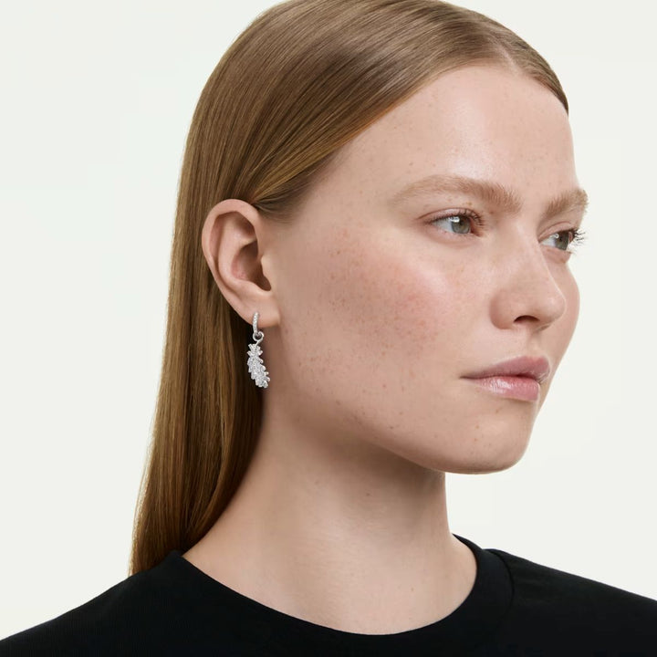Niche Jewellery Swarovski Vienna feather earrings in rhodium plating with white crystals worn by a model