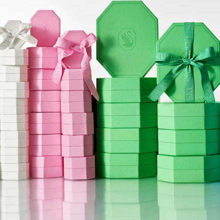 Niche Jewellery branded Swarovski gift boxes in white, pink, and green stacked for display